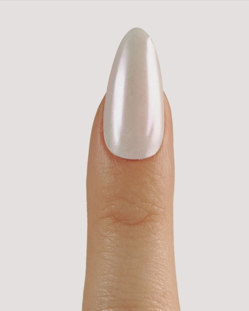 A fingernail with shiny, smooth white nail polish. The skin around is natural and clean.
