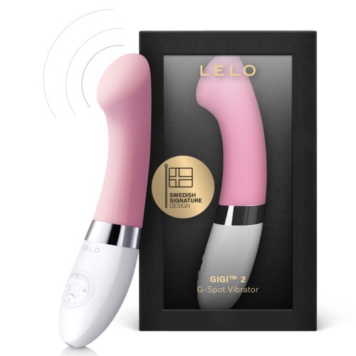 Rosa G-Punkt-Vibrator mit weißem Griff, schwarzem Metallring und Verpackungsschachtel mit 'LELO GIGI' Beschriftung.