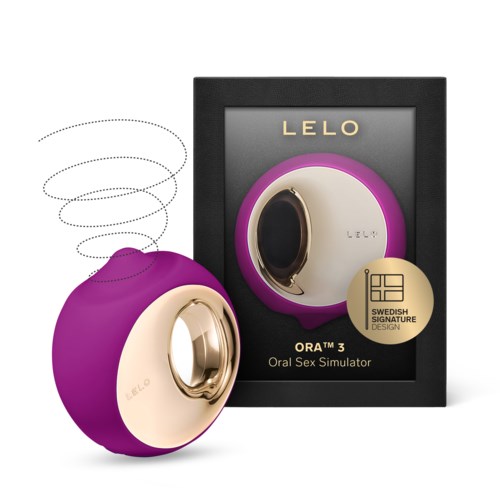 A purple and gold device with a circular mirror shape, packaged alongside a black box with gold and purple details.
