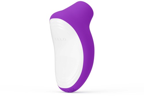 En handhållen enhet i lila och vitt med en böjd form, sannolikt en personlig vårdprodukt eller groomingprodukt.