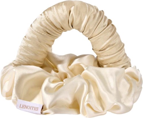 A beige satin headband with a scrunched fabric design and a satin bow. It has a LENOBITS tag.