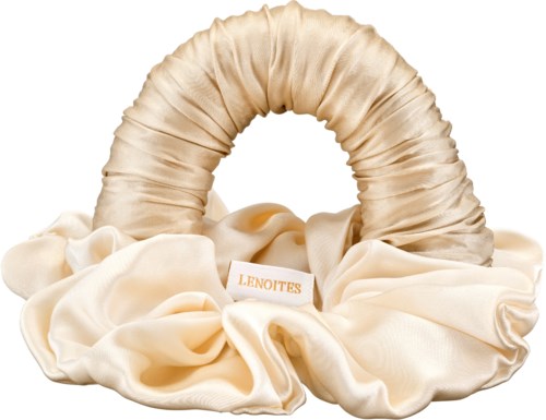 A beige fabric hair bonnet surrounded by soft, cream-colored fabric and a tag labeled "LENOITES."