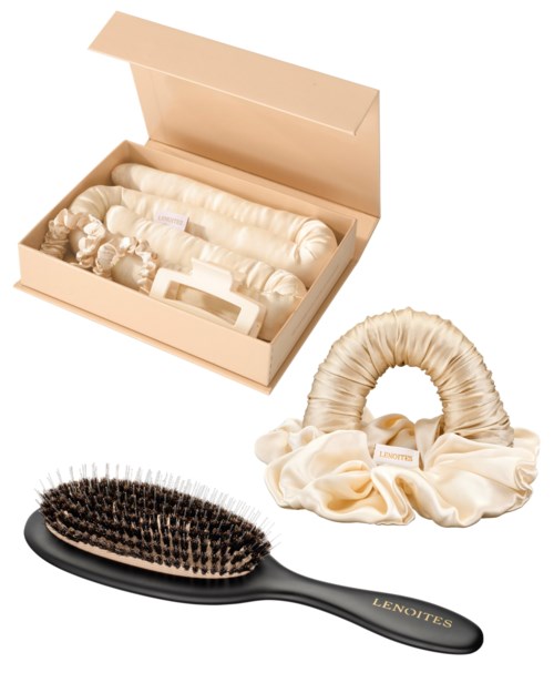 A hairbrush, a satin scrunchie, and a box of accessories for hair are shown.