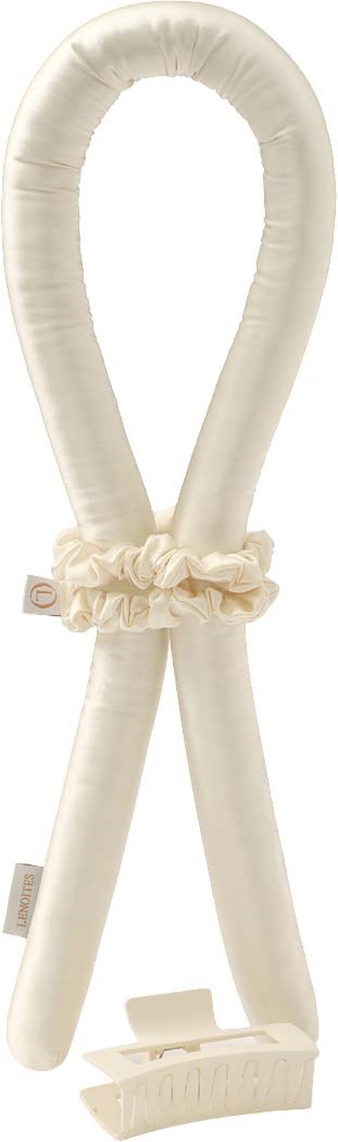 A soft, cream-colored U-shaped cushion with a ruffled fabric band around the middle.