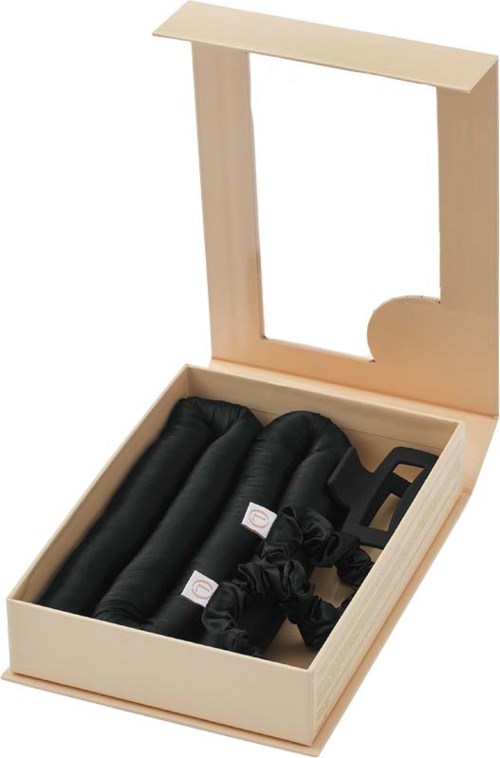A wooden box with a mirror and four rolled black socks inside.