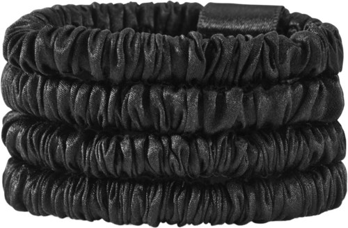 Four black, ruffled elastic hairbands stacked together.