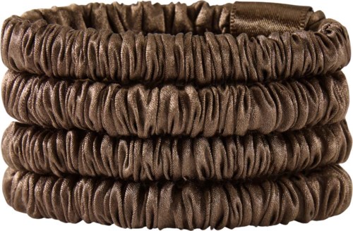 A stack of five brown, stretchy hairbands or scrunchies made of soft, shiny fabric.