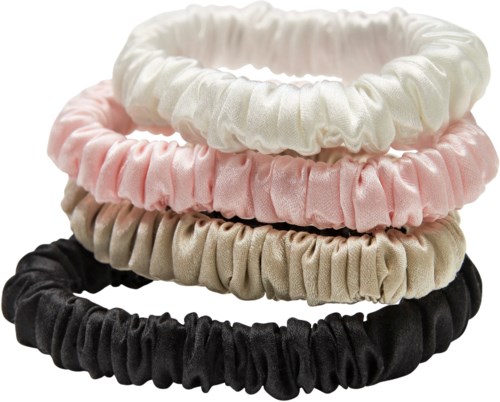 Four fabric hairbands in white, pink, beige, and black stacked with elastic gathered material.