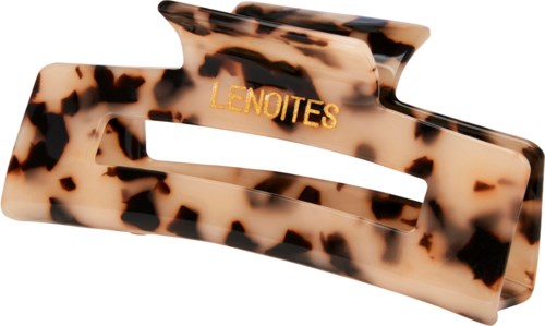 A hair clip with a tortoise shell pattern and gold lettering that says "LENOITES."