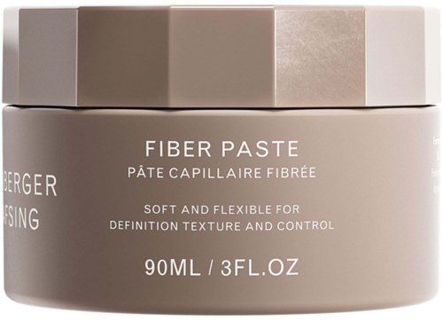 En rund burk med fiberpasta för hårvård, med beige och vit lock, etiketten visar produktens namn och användning.