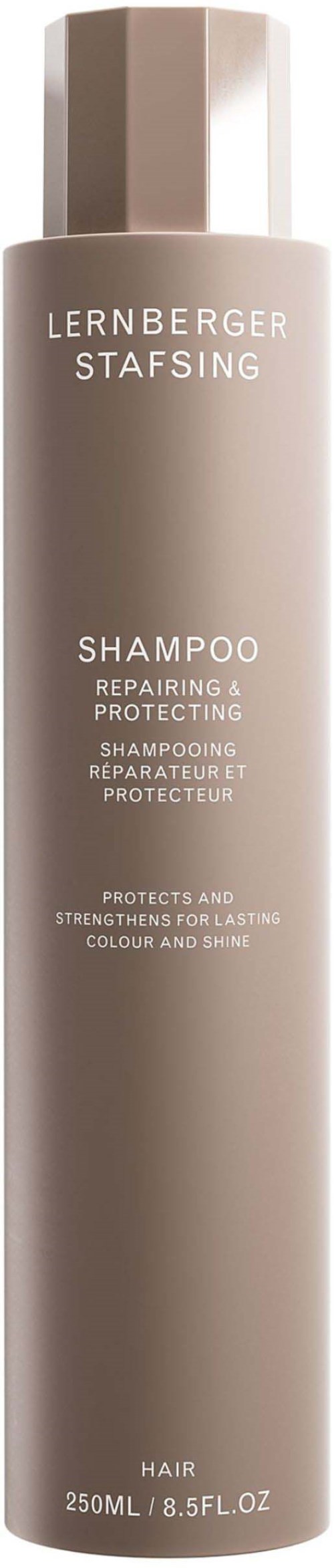 Eine lange,beige Shampoo-Flasche mit silberner Kappe, für Haarreparatur und Schutz.
