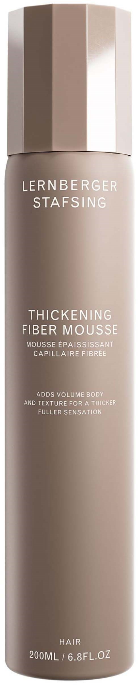 Eine lange, beige Sprühflasche mit glänzendem Deckel, gekennzeichnet als Verdickung Fibermousse für Haare.