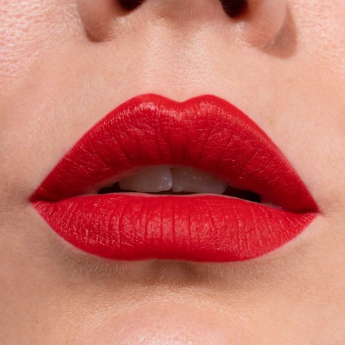 Close-up of lips with bright red lipstick, slightly parted showing teeth, smooth skin around.