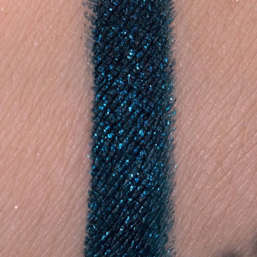 Close-up of a blue, shimmery, textured line on skin.