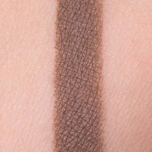 Close-up of a brownish tattoo or makeup line on skin, with fine details of skin texture visible.