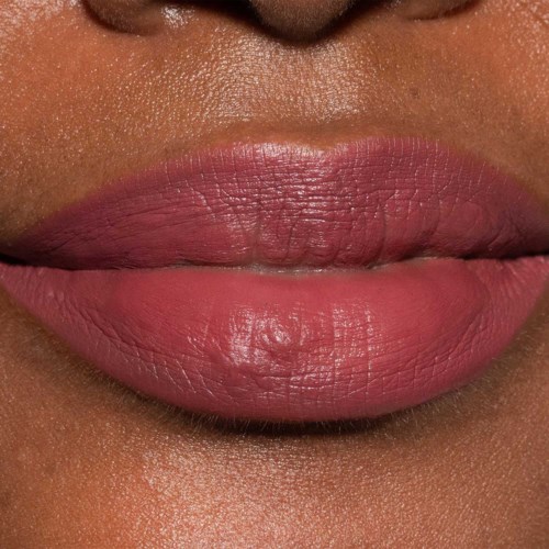 Close-up of lips with pink lipstick and visible texture. Skin around lips shows natural details.
