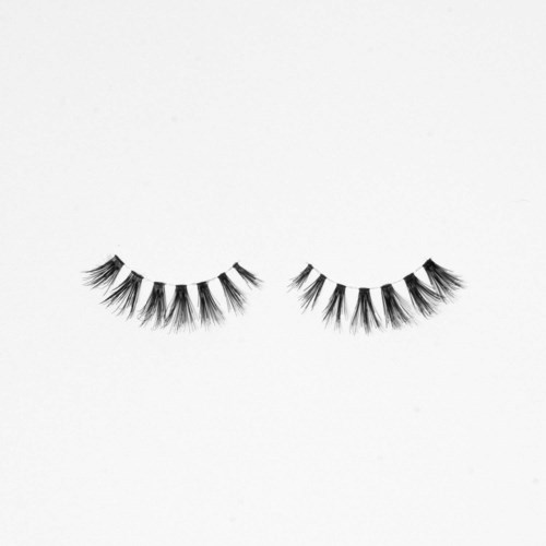 A pair of false eyelashes with thick, long, and dark synthetic hairs, placed on a plain white background.