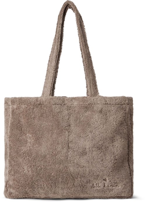 A soft, gray, fluffy tote bag with two handles and small writing on the bottom corner.