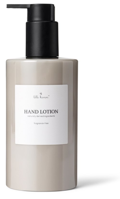 Beige tynnyri, jossa lukee 'Hand Lotion', musta pulpettipää, yksinkertainen suunnittelu, ja valkoinen tarra.