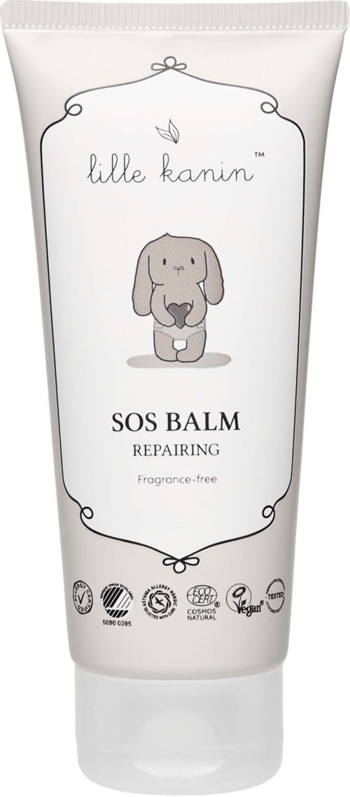 Eine weiße Tube mit einem niedlichen Hundbild, beschriftet 'SOS Balm Repairing' und 'Fragrance-free', von Lille Kanin.