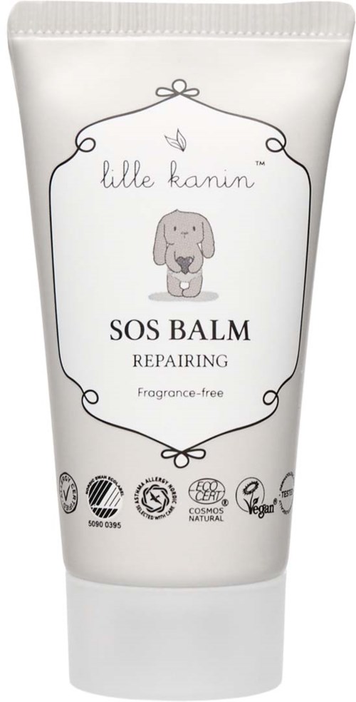 Weiße Tube mit SOS-Balm zur Reparatur, mit niedlicher Hundillustration und Zertifizierungssymbolen. Markenname ist 'lille kune'.