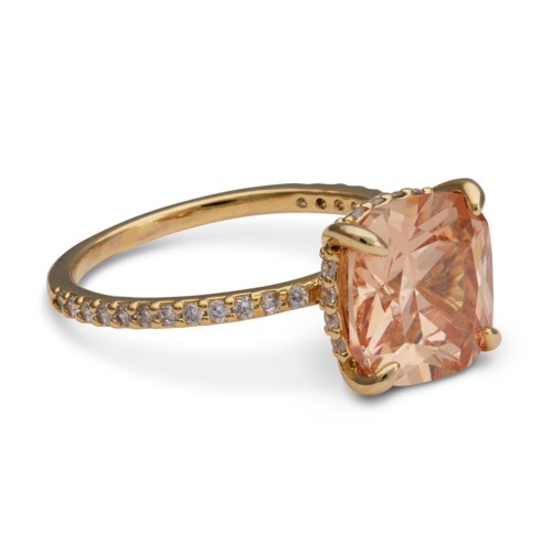 Gold ring with a large peach-colored gemstone and small diamonds along the band.