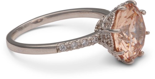A silver ring with many small diamonds and a large peach-colored gemstone in the center.