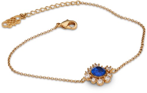 A gold bracelet with a blue gemstone surrounded by small clear stones and a floral charm.