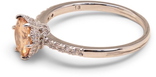Gold ring with a large peach-colored gemstone and small surrounding crystals.