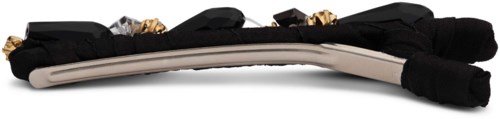A black fabric headband with decorative elements and a shiny metal band in the middle.