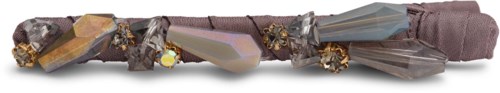 A decorative belt with shiny, pointed crystals and small gold beads on a purple fabric strap.
