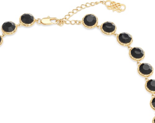 A gold necklace with black stones and a chain extension with a clasp.