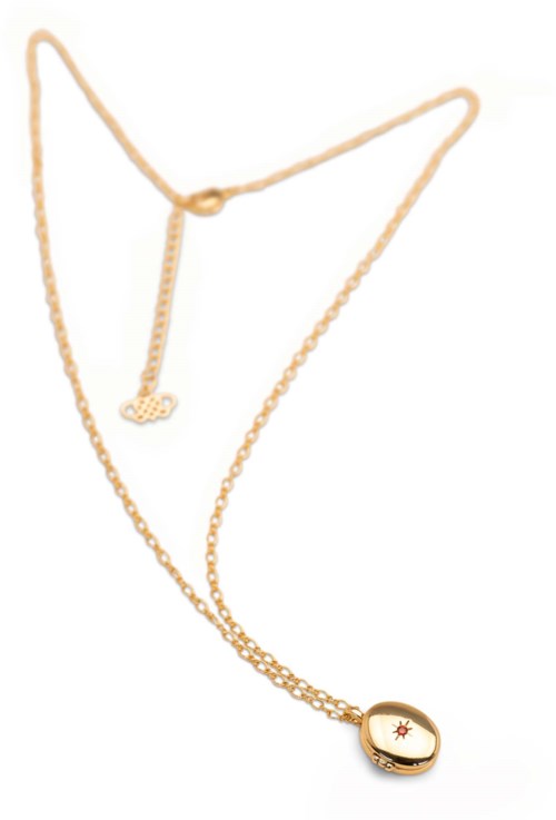 Gold necklace with a small round pendant featuring a star and eye design.