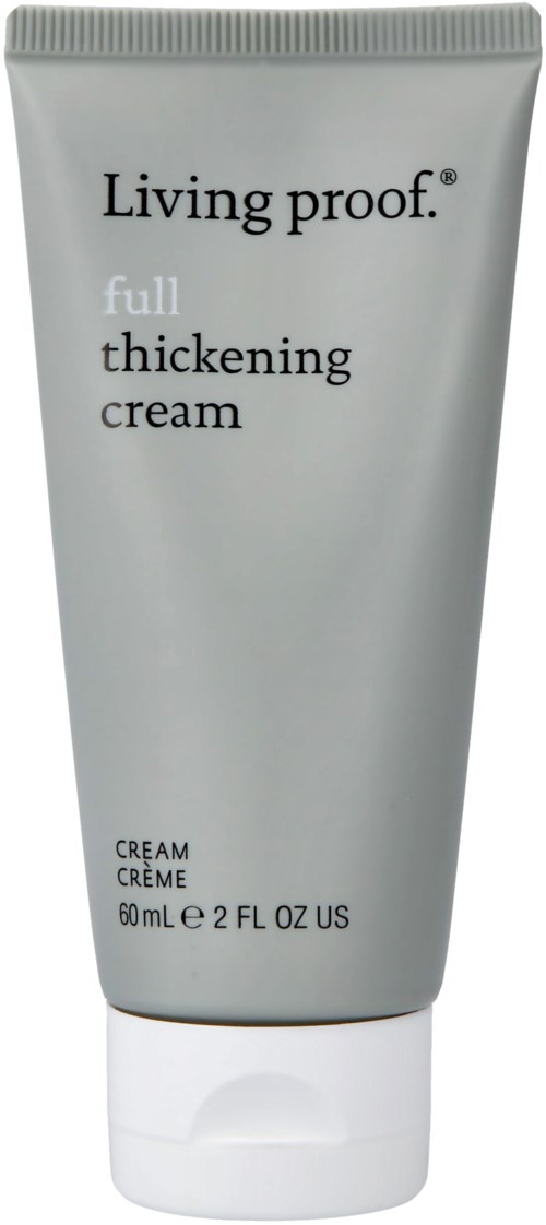 En silver tub med Living Proof full thickening kräm med svart och vitt text. Den är upprättstående med vit lock.