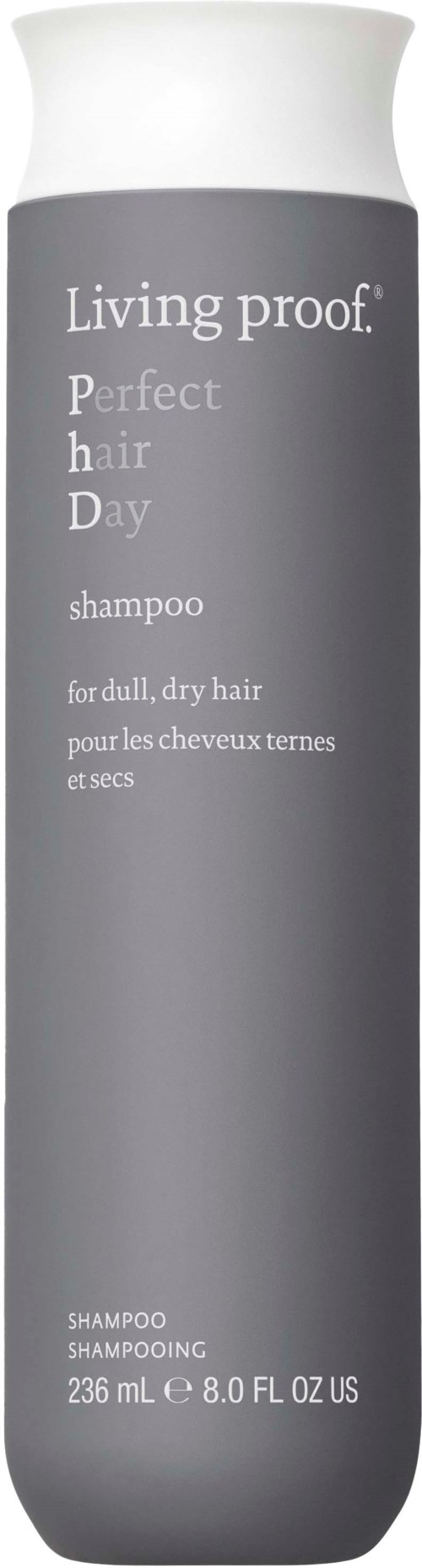 Harmaa shampoopullo, jossa valkoinen korkki, nimeltä Living Proof Perfect Hair Day, kuivalle ja kuolleelle hiukselle.