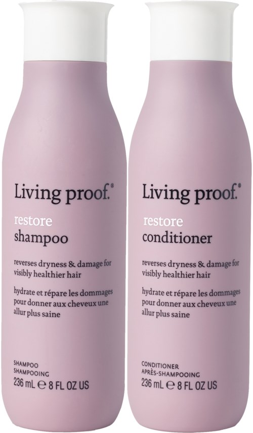 To rosa flasker med Living Proof hårpleieprodukter, en sjampo og en balsam, med enkle etiketter.