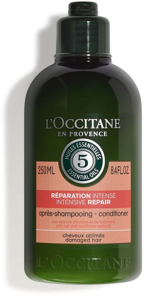 Eine dunkelgrüne Flasche L'Occitane Haarkur, 250ml, mit pinkem und weißem Etikett für intensive Reparatur.