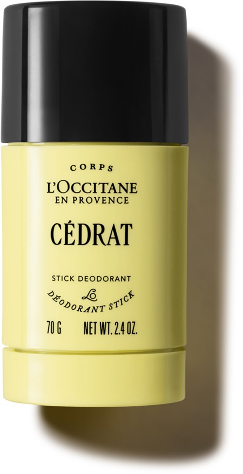 Een gele deodorantstift met zwarte dop, gelabeld "Cedrat" door L'Occitane, in een eenvoudig, schoon ontwerp.