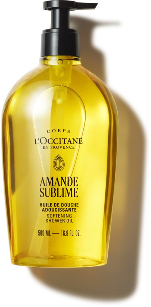 Eine gelbe Duschöl-Flasche mit schwarzem Pumphahn, kennzeichnet Amande Sublime, von L'Occitane in Provence.