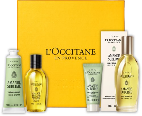 Set mit gelbem Karton und fünf Hautpflegeprodukten, darunter Handcreme, Körperöl und Lotionen von L'Occitane.