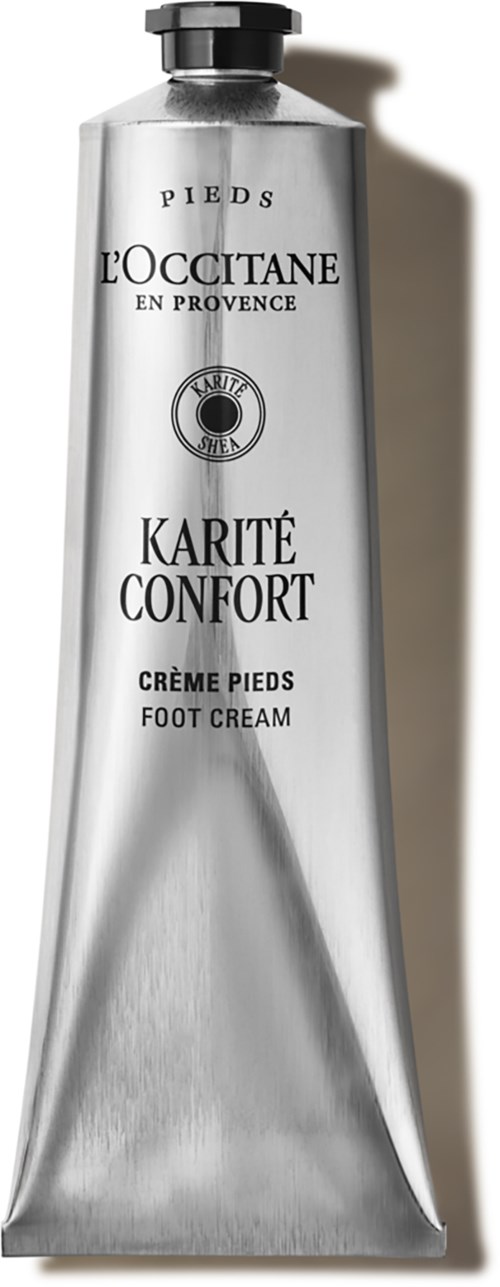 En silverrör med L'Occitane fotkräm, svart lock, märkning 'Karité Confort' för torra fötter.