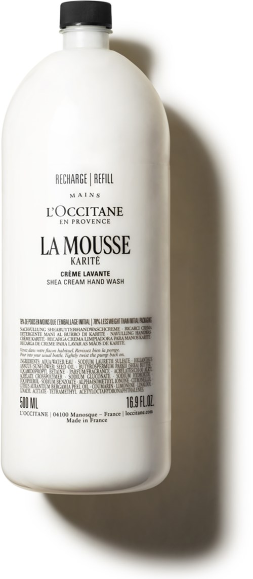Eine weiße Flasche mit L'Occitane Shea-Creme-Handwäsche, schwarzer Kappe und schwarzen Text.