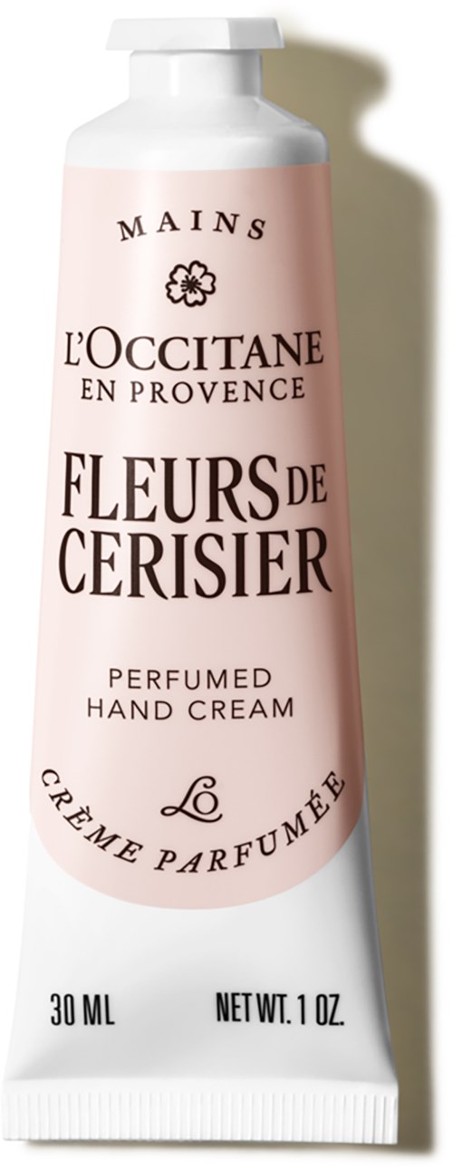 Eine pink-weiße Tube mit Parfüm-Handcreme, französischer Text und Marke L'Occitane. 30 ml.