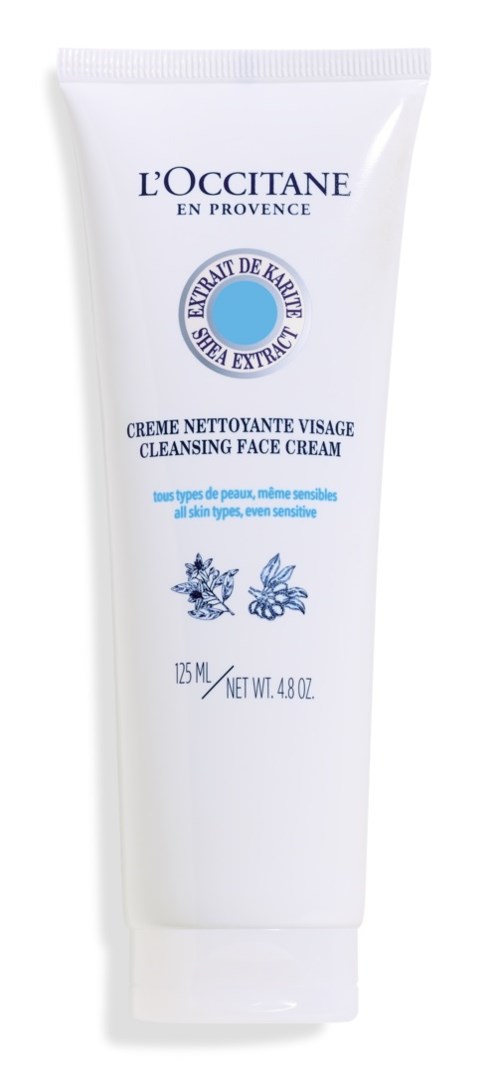 Valkoinen putkilopakkaus kasvojen puhdistusvoiteesta L'Occitane:lta, sinisellä tekstillä ja yrtti-illustraatioilla.