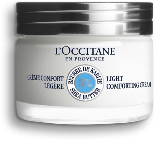 Ein weißer Behälter mit leichter beruhigender Creme, schwarzer Deckel, blaue und schwarze Schrift über Sheabutter.