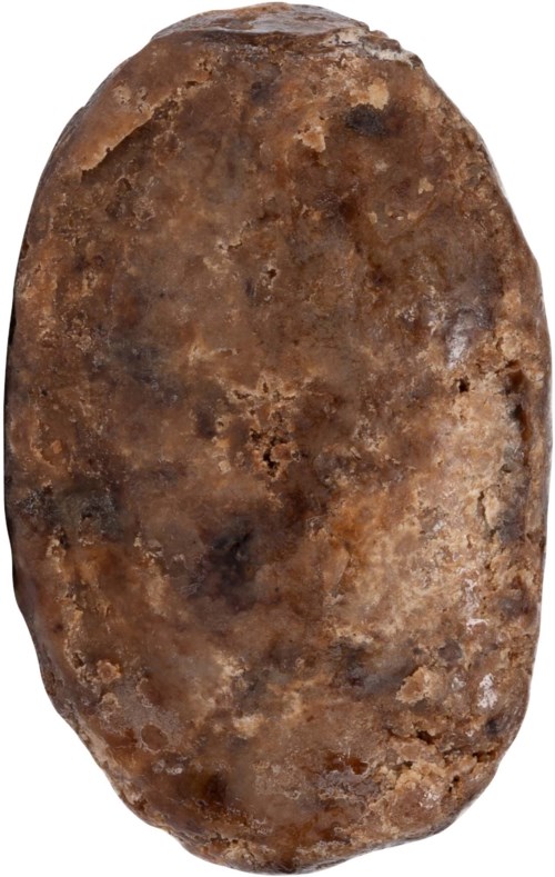 A brown, irregularly shaped potato with a rough, uneven surface and some dark spots.