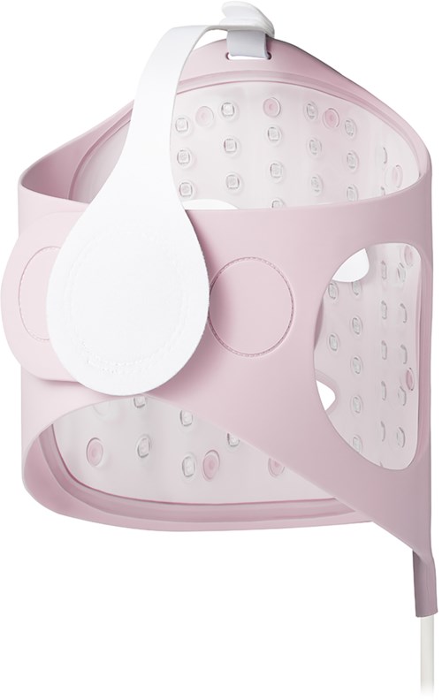 Pink and white hair dryer with a circular design and multiple air holes.