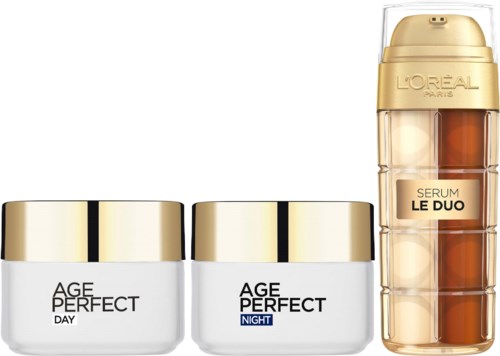 Lippenbalsem en huidverzorgingspotjes met gouden deksels en een gouden serumfles. Ze zijn gelabeld voor dag, nacht en serum.