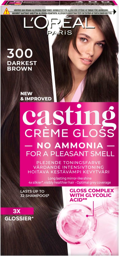 Haarverfverpakking met een gezicht van een vrouw, productnaam, kleur en voordelen op de voorkant.