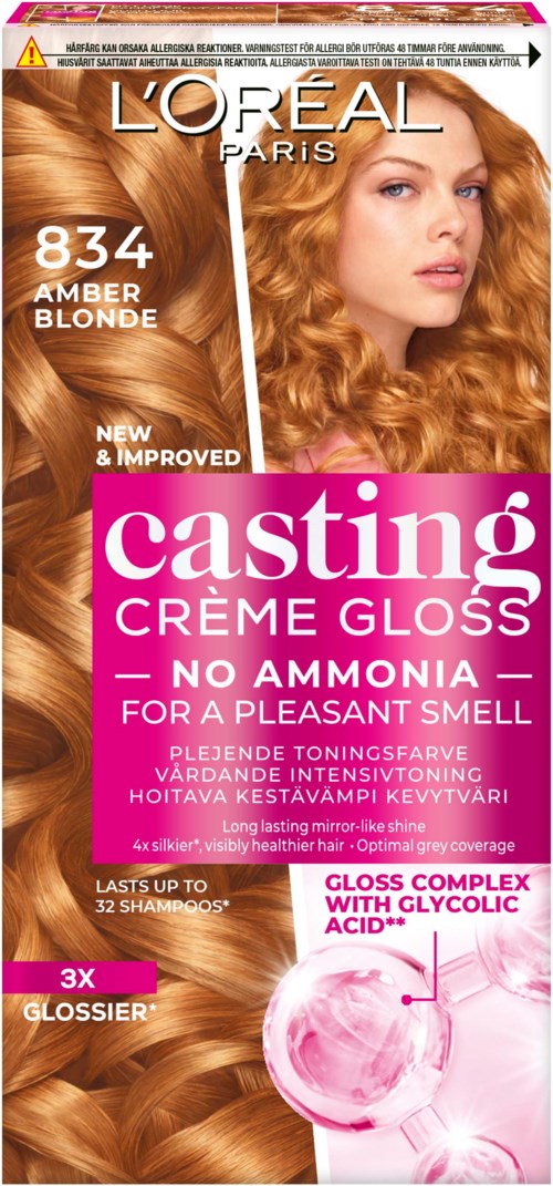 Een haarverfdoos voor L'Oréal Casting Crème Gloss Amber Blonde, met een vrouw met glanzend, krullend blond haar.
